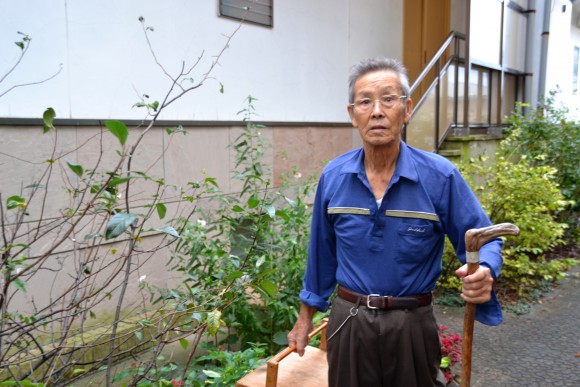 稲井幸夫（76）畑で、愛和館のネギがキレないように育てています。